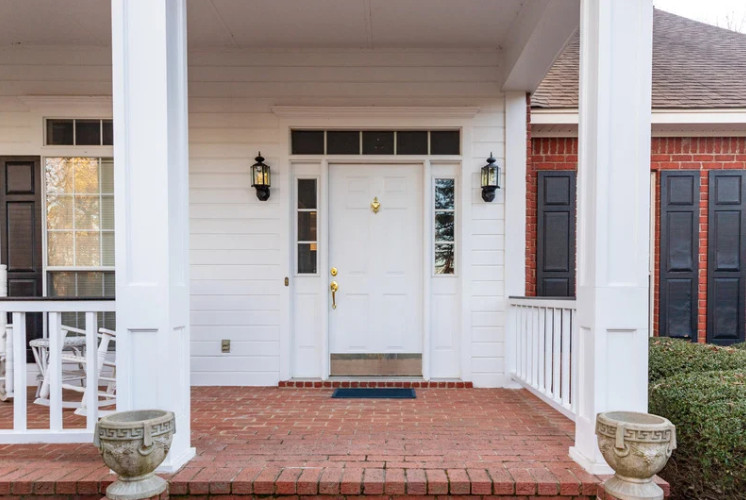 A welcoming home entrance showcases a bold new door, illustrating why it's smart to replace your front door.