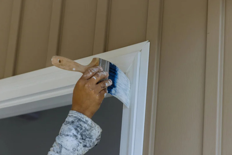 A modern home facade highlights clean, detailed exterior window trim that frames each window with precision and style.